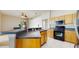 Bright kitchen features a breakfast bar, stainless steel appliances, gas range, and ample cabinet space at 2728 Abbey Grove Dr, Valrico, FL 33594
