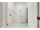 Laundry room featuring white tile flooring and washer/dryer hookups at 2728 Abbey Grove Dr, Valrico, FL 33594