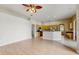 Open-concept living room with wood floors that connects seamlessly to the kitchen and dining areas at 2728 Abbey Grove Dr, Valrico, FL 33594