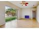 Bright living room with wood floors, ceiling fan, and sliding glass doors to the outdoor space at 2728 Abbey Grove Dr, Valrico, FL 33594