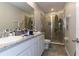 Bright bathroom features granite counters, white cabinets, and a glass-enclosed shower at 2801 Midnight Pearl Dr, Sarasota, FL 34240