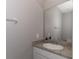 Powder room featuring a granite countertop and a framed mirror at 2801 Midnight Pearl Dr, Sarasota, FL 34240
