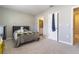 Bedroom with neutral walls and carpet, plus doorway to bath at 2801 Midnight Pearl Dr, Sarasota, FL 34240