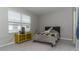 Bedroom featuring a bed, yellow TV stand, and window offering natural light and neighborhood views at 2801 Midnight Pearl Dr, Sarasota, FL 34240