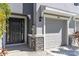 Close up of the front door, and one car garage door of the townhome at 2801 Midnight Pearl Dr, Sarasota, FL 34240