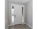 Inviting foyer with neutral tile flooring and sidelights flanking the front door at 2801 Midnight Pearl Dr, Sarasota, FL 34240