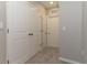 Hallway featuring neutral walls, plush carpeting, and multiple white doors leading to rooms at 2801 Midnight Pearl Dr, Sarasota, FL 34240