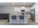 Modern kitchen featuring stainless steel appliances, granite countertops, and a stylish island with barstool seating at 2801 Midnight Pearl Dr, Sarasota, FL 34240