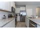 Kitchen showcasing granite counters, stainless steel appliances, white cabinets and a subway tile backsplash at 2801 Midnight Pearl Dr, Sarasota, FL 34240