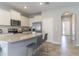 Bright kitchen showcasing stainless appliances, granite counters, an island and an arched doorway leading to the foyer at 2801 Midnight Pearl Dr, Sarasota, FL 34240