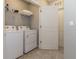 Bright laundry area with a washer, dryer, and open doorway at 2801 Midnight Pearl Dr, Sarasota, FL 34240
