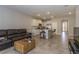 Open-concept living room with a modern kitchen, tile floors, and an island with bar seating at 2801 Midnight Pearl Dr, Sarasota, FL 34240
