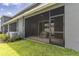 Spacious screened-in patio and adjacent backyard with lush green grass and privacy fence at 2801 Midnight Pearl Dr, Sarasota, FL 34240