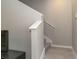 Carpeted staircase and railing along a white post at 2801 Midnight Pearl Dr, Sarasota, FL 34240