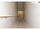 Carpeted staircase descending into the lower level with a handrail and neutral walls at 2801 Midnight Pearl Dr, Sarasota, FL 34240