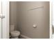 Neutral powder room with tiled floors, toilet and white trim at 2801 Midnight Pearl Dr, Sarasota, FL 34240
