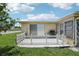 Concrete patio features a grill, fenced yard, and sliding glass door at 3401 Pinon Dr, Holiday, FL 34691