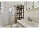 Cozy bathroom with shower/tub combination and shelving unit for storage at 3401 Pinon Dr, Holiday, FL 34691