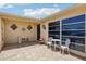 Inviting courtyard with stylish tile flooring, decorative wall accents, and comfortable seating for outdoor relaxation and gatherings at 3401 Pinon Dr, Holiday, FL 34691