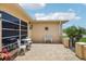 Charming outdoor patio featuring a seating area, decorative accents, and tiled flooring, perfect for relaxing and entertaining at 3401 Pinon Dr, Holiday, FL 34691