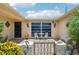 Enchanting courtyard featuring tiled flooring, decorative wrought iron gate, and cozy seating, creating a tranquil outdoor space at 3401 Pinon Dr, Holiday, FL 34691