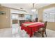 Combined dining and kitchen area showing the tile flooring and connectivity between dining and food prep at 3401 Pinon Dr, Holiday, FL 34691