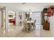 Dining area displaying tile flooring, elegant dining set, and open flow to a connecting room at 3401 Pinon Dr, Holiday, FL 34691