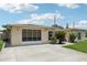 Single-story home featuring a driveway and screened-in garage in a well-maintained neighborhood with mature landscaping at 3401 Pinon Dr, Holiday, FL 34691