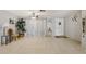 Spacious living room with tiled flooring, a ceiling fan, and natural light, creating a bright and welcoming atmosphere at 3401 Pinon Dr, Holiday, FL 34691