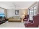 Living room showcases a comfortable seating arrangement, ceiling fan, and sliding glass door to a porch at 3401 Pinon Dr, Holiday, FL 34691