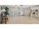 Bright and airy living room featuring tiled flooring, a decorative ceiling fan, and large windows, perfect for relaxation and entertaining at 3401 Pinon Dr, Holiday, FL 34691