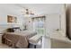 Bright bedroom with tiled floors, ceiling fan, dresser, bench and window view of outdoors at 3401 Pinon Dr, Holiday, FL 34691
