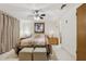 Bright bedroom with tile floors, a ceiling fan and ensuite access at 3401 Pinon Dr, Holiday, FL 34691