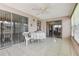 Tiled sunroom featuring ceiling fan, multiple sliding glass doors and windows at 3401 Pinon Dr, Holiday, FL 34691