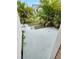Backyard featuring a concrete patio area and lush tropical landscaping, creating a private outdoor space at 34091 Alamanda N Dr, Pinellas Park, FL 33781