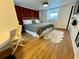 Comfortable bedroom featuring a cozy bed, wood flooring, and ample closet space at 34091 Alamanda N Dr, Pinellas Park, FL 33781
