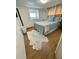 Comfortable bedroom featuring natural light, a bed with an accent rug, and wood flooring at 34091 Alamanda N Dr, Pinellas Park, FL 33781