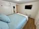 Bedroom featuring a large bed, wood floors, and a closet with sliding doors at 34091 Alamanda N Dr, Pinellas Park, FL 33781
