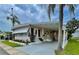 Charming single-story home with covered parking, inviting entrance, and beautifully landscaped front yard at 34091 Alamanda N Dr, Pinellas Park, FL 33781