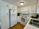 Bright kitchen featuring updated appliances and ample cabinet space, providing a functional cooking environment at 34091 Alamanda N Dr, Pinellas Park, FL 33781