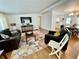 Inviting living room with laminate flooring, large TV, and an open layout flowing into dining at 34091 Alamanda N Dr, Pinellas Park, FL 33781