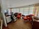 Living room with large windows providing ample natural light, decorative furniture, and wood floors at 34091 Alamanda N Dr, Pinellas Park, FL 33781