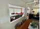 Bright and airy living room featuring multiple seating arrangements and wood flooring at 34091 Alamanda N Dr, Pinellas Park, FL 33781