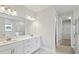 Bright bathroom features double sinks, white cabinetry, and a walk-in closet at 3448 Yellow Leaf Cir, Spring Hill, FL 34609