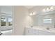 Bright bathroom features double sinks and a large vanity mirror at 3448 Yellow Leaf Cir, Spring Hill, FL 34609