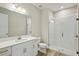 Bright bathroom features a glass shower and a large vanity mirror at 3448 Yellow Leaf Cir, Spring Hill, FL 34609