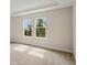 Bright bedroom featuring plush carpet and two windows at 3448 Yellow Leaf Cir, Spring Hill, FL 34609