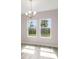 Dining room with large windows offering a view of the outdoors and stylish chandelier at 3448 Yellow Leaf Cir, Spring Hill, FL 34609