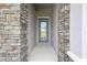 Inviting entrance with stone pillars and a beautifully designed front door at 3448 Yellow Leaf Cir, Spring Hill, FL 34609