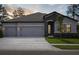 Beautiful single-Gathering home with a stone-accented entrance and a three-car garage at 3448 Yellow Leaf Cir, Spring Hill, FL 34609